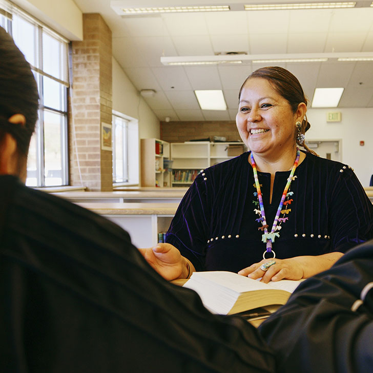 Smiling provider consults with patients.